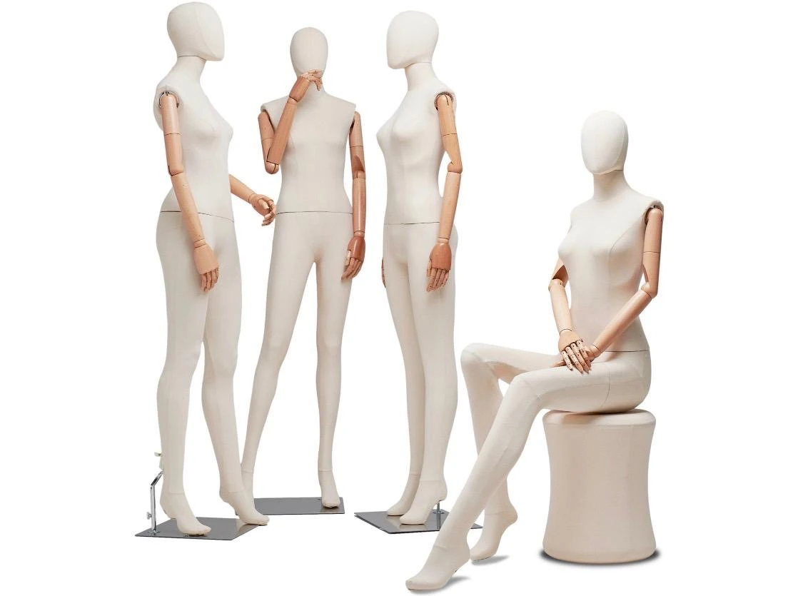 White mannequins with articulated arms including a seated figure